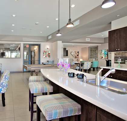 a view of a restaurant with a bar and chairs