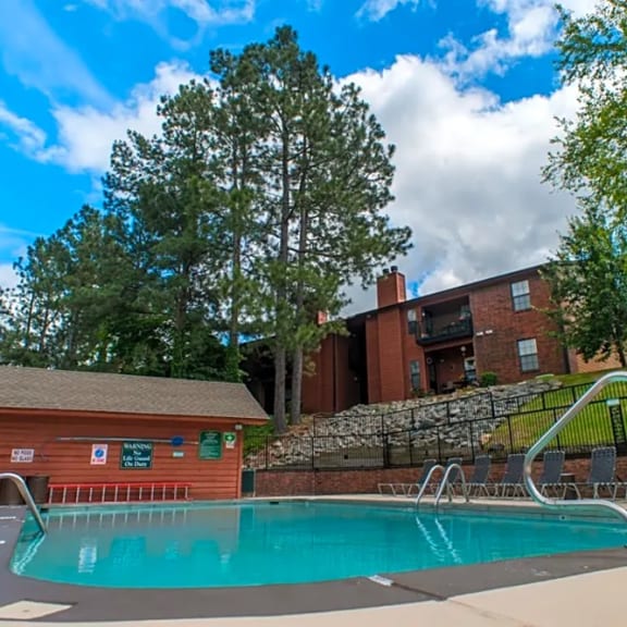 a swimming pool with a building in the background