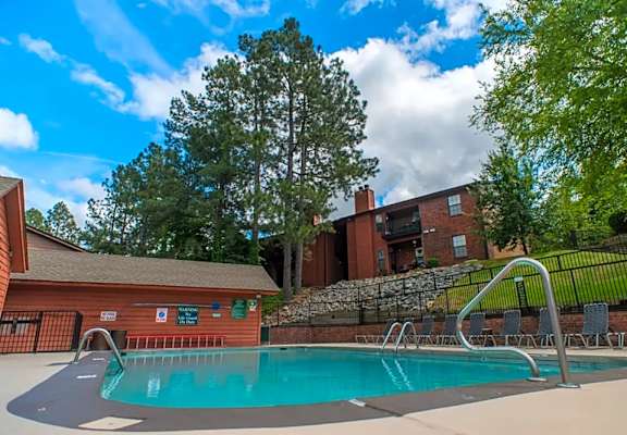 a swimming pool with a building in the background