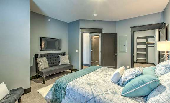 Large apartment bedroom with space for sitting areas and a walk-in closet
