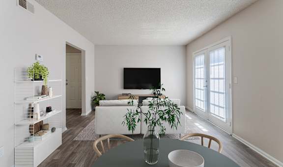 A living room with a grey table and a white couch.