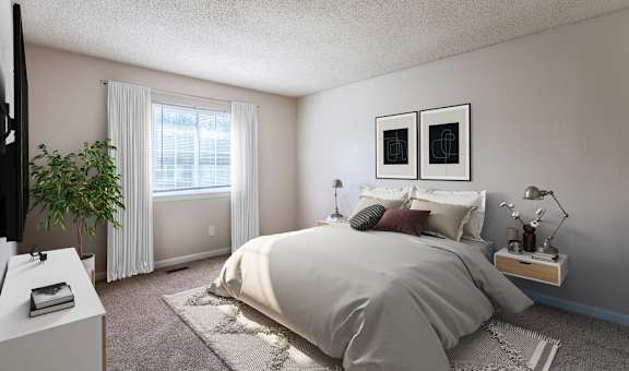 A bedroom with a large bed and a flat screen TV.
