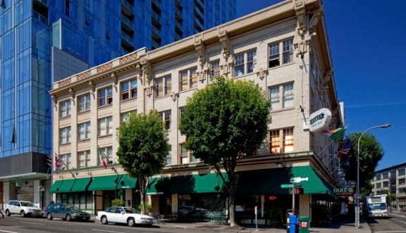 a building on the corner of a city street at Maurice Dear Apartments, Portland