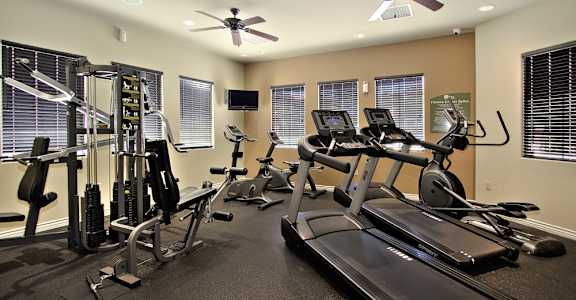 a gym with treadmills and other exercise equipment