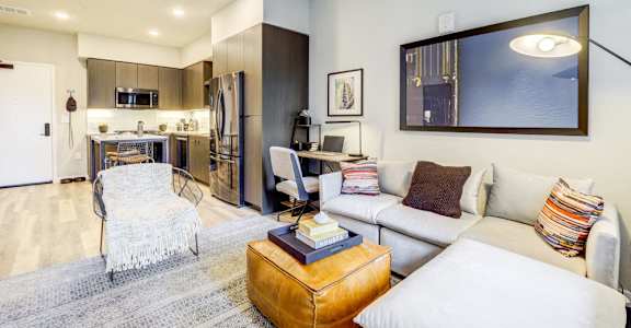 A modern living room with a white couch and a coffee table.