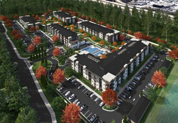 an aerial view of a development of townhomes with cars parked on the side of the