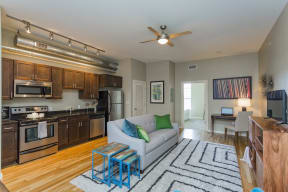 Gale Lofts - Open Style Floor Plan Featuring Living Room and Kitchen with Wood-Style Flooring and Matching Cabinets