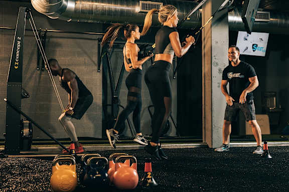 A woman is exercising with a resistance band in a gym. at Palma, Doral, Florida