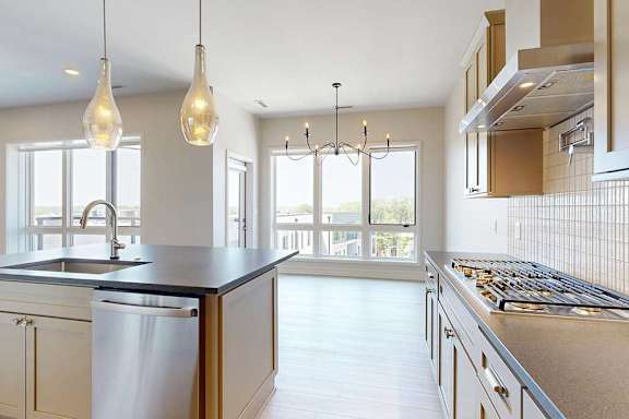 A penthouse with large island and stainless steel appliances.
