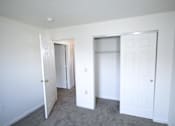 Thumbnail 15 of 16 - a bedroom with a closet and a carpeted floor