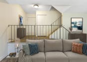 Thumbnail 3 of 13 - a living room with a couch and a staircase in the background at Copper and Quarry Village, Pikesville, MD, 21209