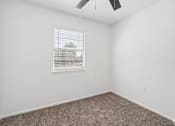 Thumbnail 11 of 15 - A room with a window and a ceiling fan.