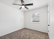 Thumbnail 13 of 15 - A room with a ceiling fan and a window with blinds.