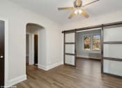 Thumbnail 6 of 15 - a bedroom with a ceiling fan and a window