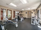 Thumbnail 23 of 27 - Gym with cardio equipment and strength training machines at The Colony Apartments, Universal City