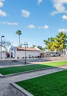 A sunny day at a park with a building in the background. at Tides on East Cactus Apartments, Phoenix