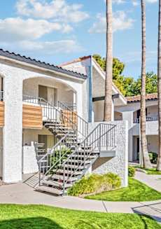 A white building with a balcony and a staircase. at Tides on East Cactus Apartments, Phoenix