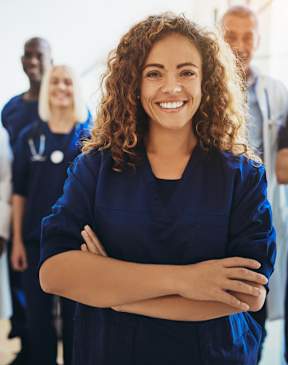 A group of medical professionals are standing together in a bright room.