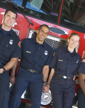 a group of people standing in front of a fire truck