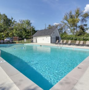 a swimming pool with a house in the background