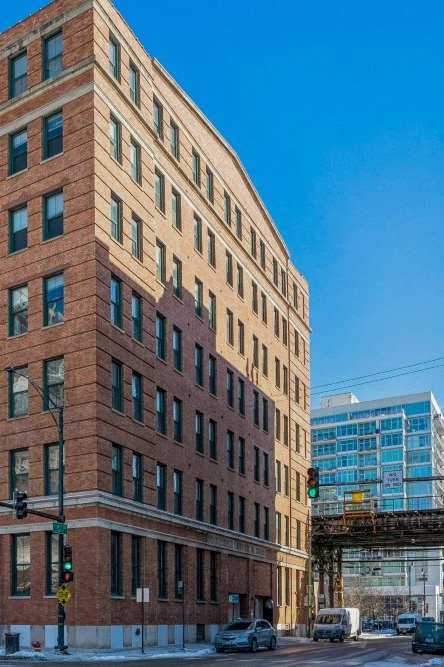 a tall brick building on a city street