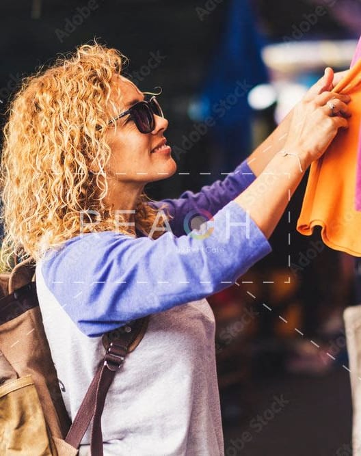 woman looking at clothes on a rack in a market at North Market South Carroll, Frederick, 21701