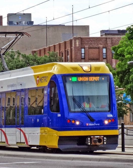 a city bus parked at a bus stop next to another bus