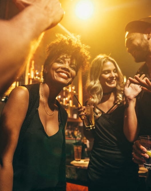 a group of people drinking at a bar