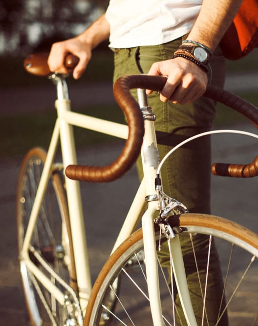 two women riding bikes down the street