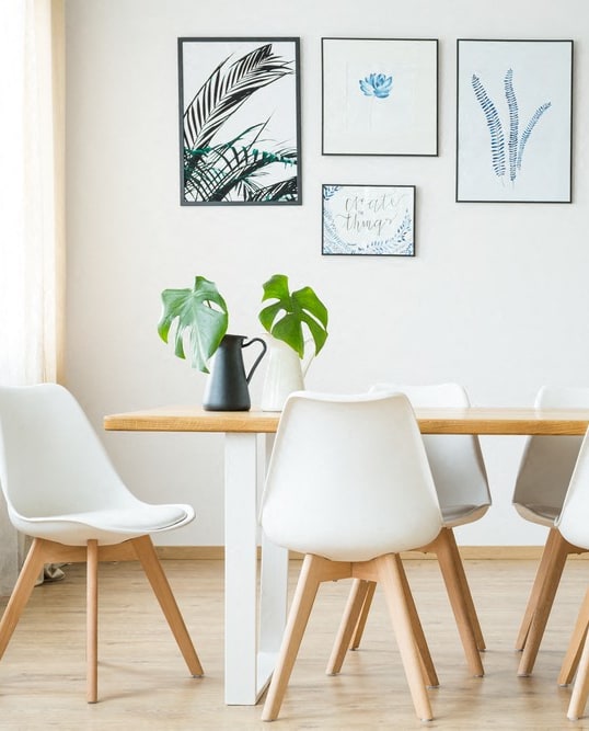 a dining room with a wooden table and white chairs