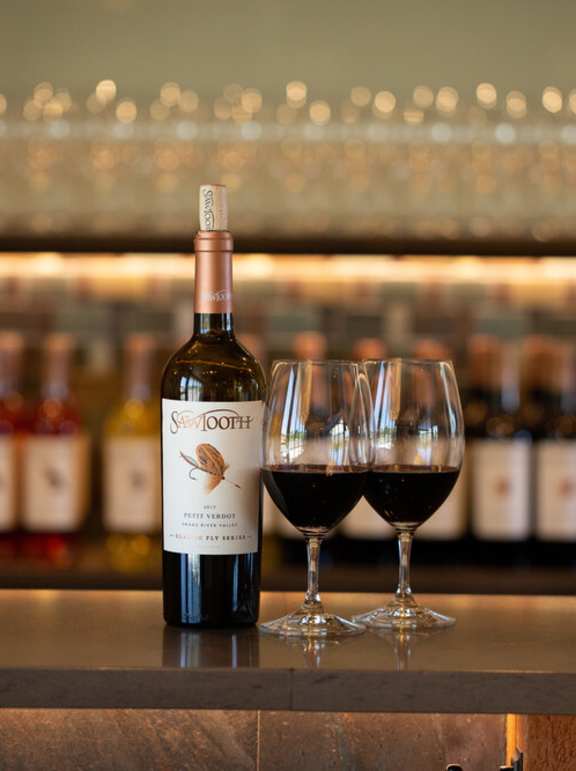 A bottle of Swan Oak wine is on a bar counter with two glasses of wine.at Alante Homes at Spring Run, Idaho, 83607