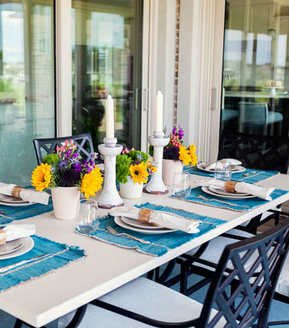a table set for a meal on the porch  at Hibiscus Place Apartments in Orlando, FL, 32808