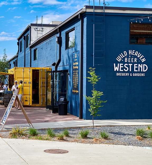 A man is taking a photo of Wild Heaven Beer West End Brewery & Gardens.