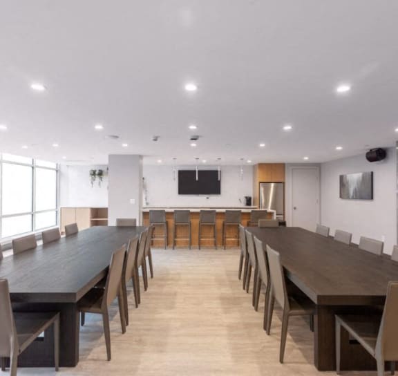 a dining room with a table and chairs and a kitchen