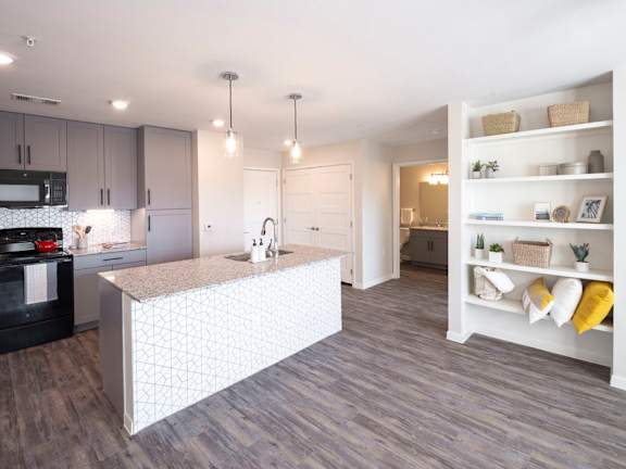 A kitchen with a white island in the middle of the room.