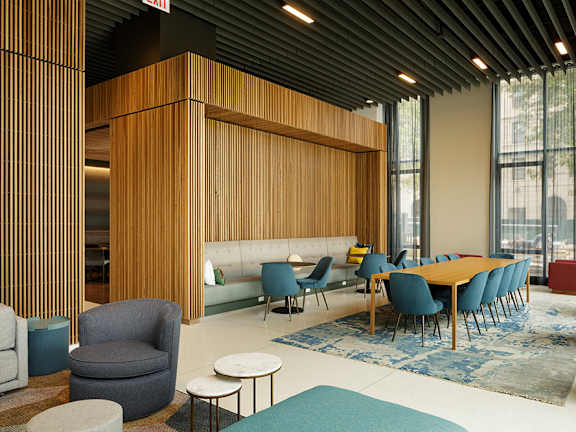 A modern room with a long table and chairs.