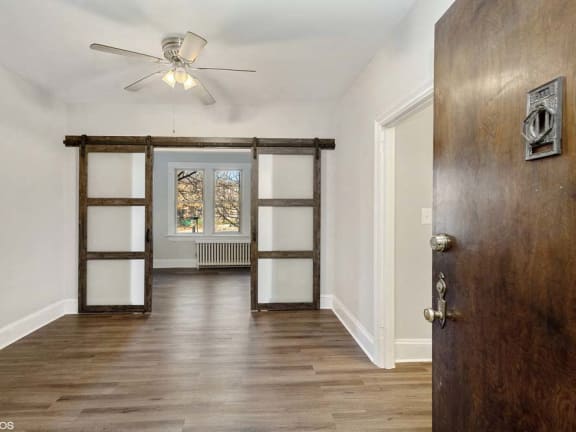 a bedroom with a ceiling fan and a window