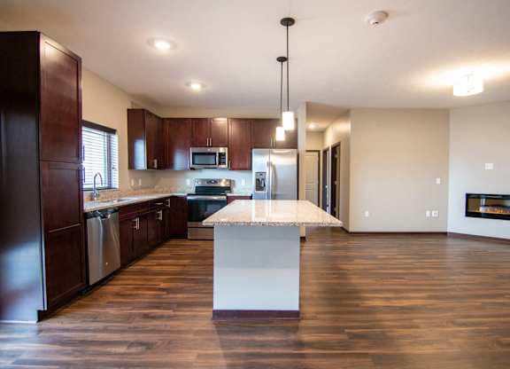 Kitchen and living room with hardwood-style flooring at 360 at Jordan West