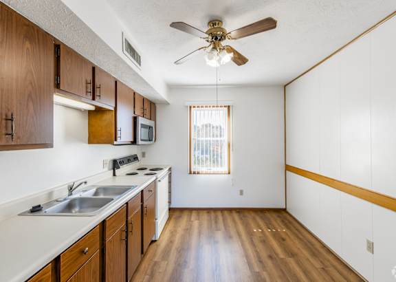 a kitchen with white cabinets and a granite counter top