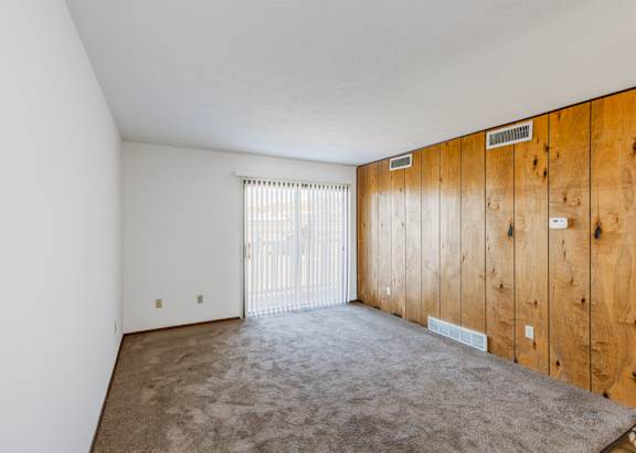 a living room filled with furniture and a ceiling fan