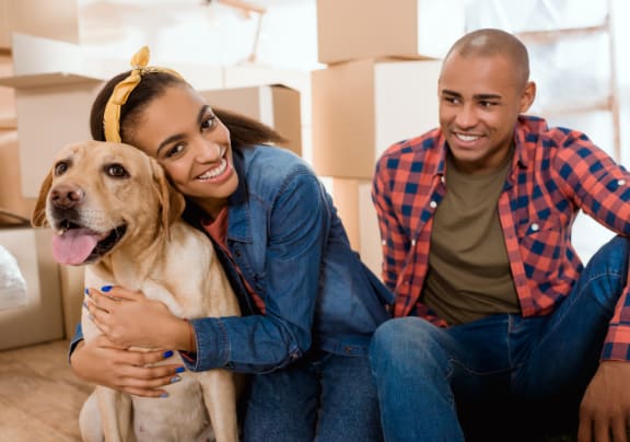 young couple sitting on the floor with their dog at Altis Grand Lake Willis, Orlando, 32821