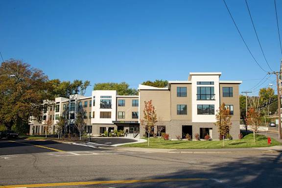 A large building with a lot of windows is in the background.