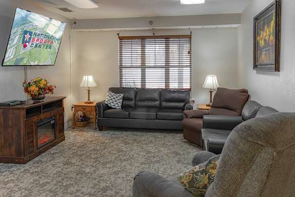 A living room with a flat screen TV and a couch.