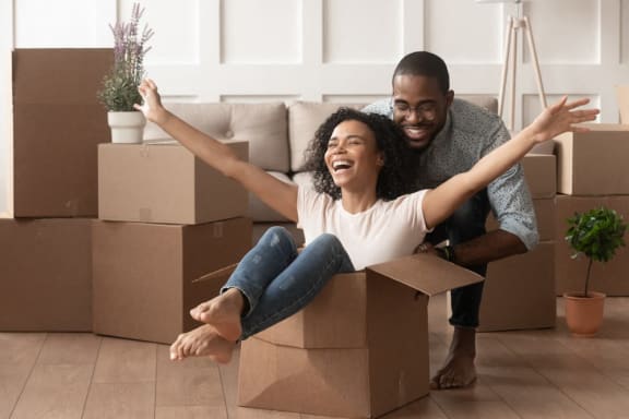 a man and woman sitting in a cardboard box at The Parker Austin, Pflugerville, 78660