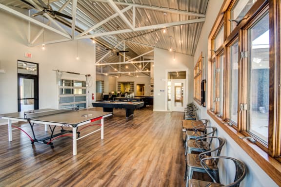 a game room with a pool table and ping pong at Aviator at Brooks, San Antonio, TX