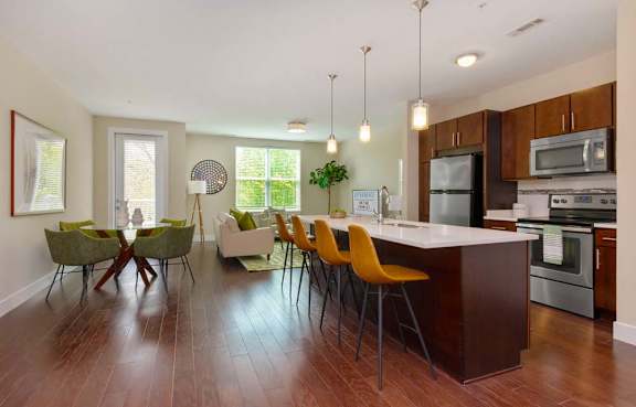 Kitchen with a long island and seating at Riverbend on the Charles in Watertown, MA.