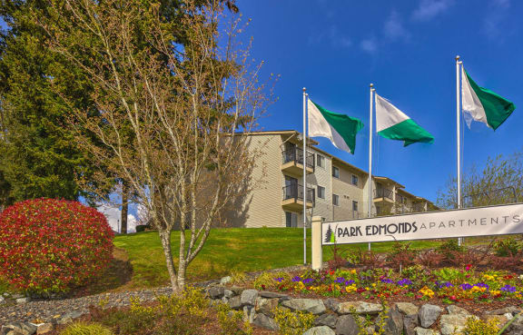 an image of the park eldorado apartments sign with flags flying in the background