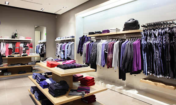 A clothing store with a variety of shirts and jackets on display.