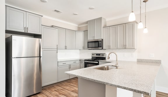 a kitchen with an island and stainless steel appliances