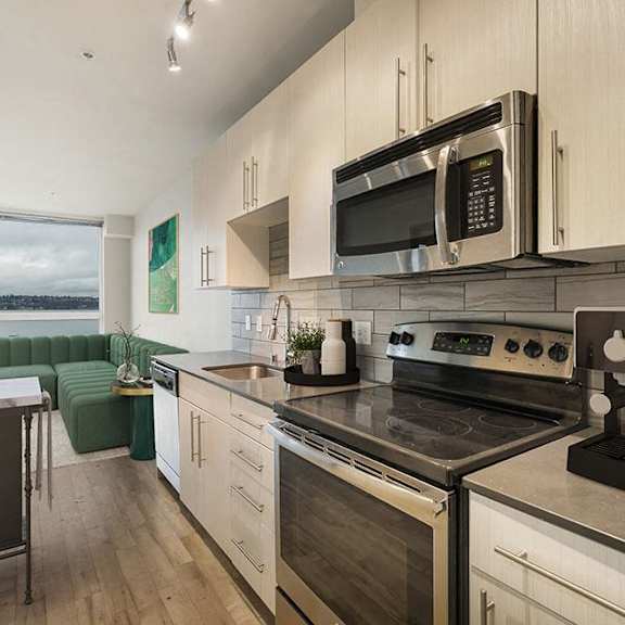 A modern kitchen with a stove top oven and microwave.